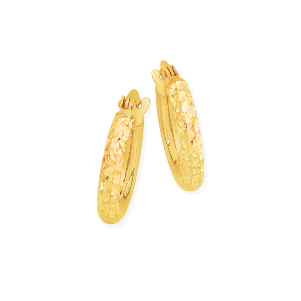 Premium Photo | 9999 gold earrings isolated on a rock